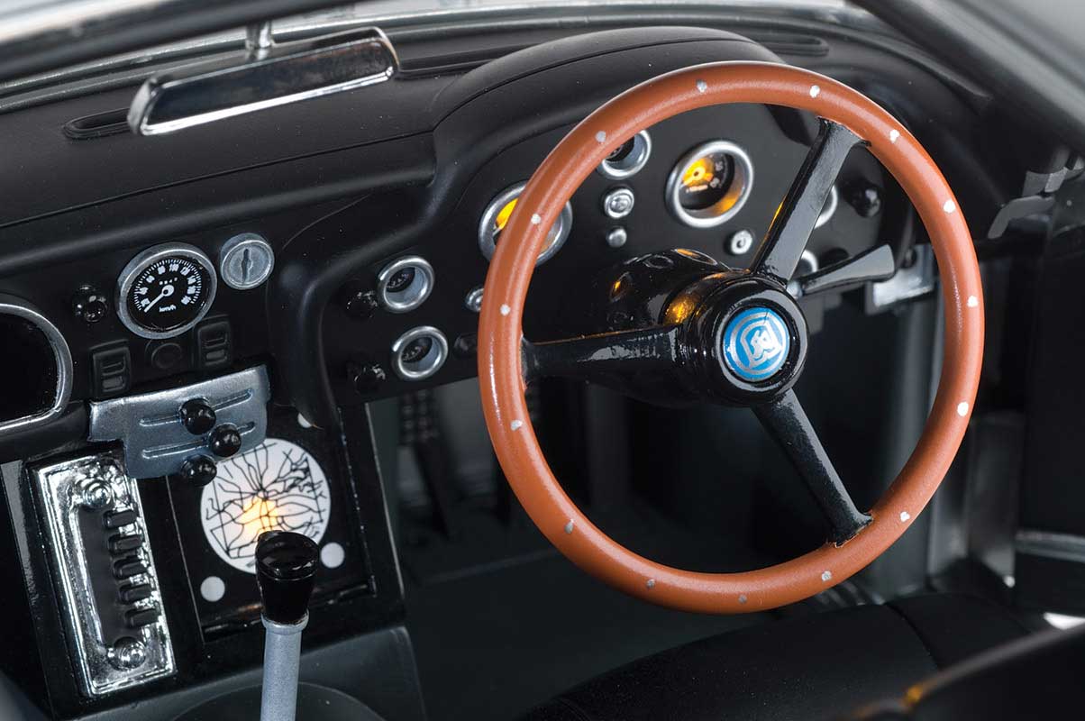 A detailed close-up of the steering wheel, dashboard, and stick shift